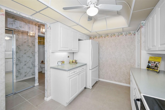 kitchen featuring light countertops, white cabinetry, ceiling fan, and light tile patterned floors