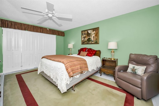 bedroom featuring a closet, ceiling fan, and a textured ceiling