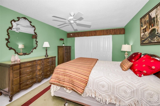 carpeted bedroom featuring a textured ceiling, ceiling fan, and a closet