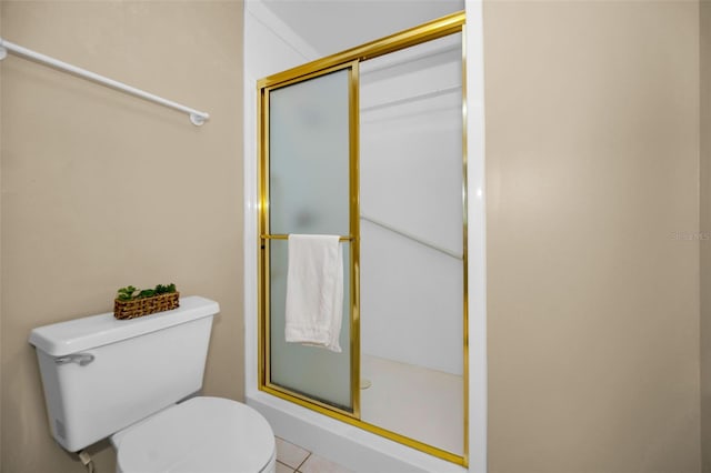 bathroom with toilet, a stall shower, and tile patterned flooring