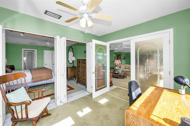 carpeted office featuring a ceiling fan, french doors, and visible vents