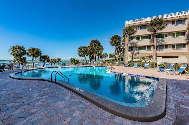 pool featuring fence and a patio