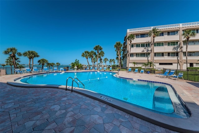 pool featuring fence and a patio