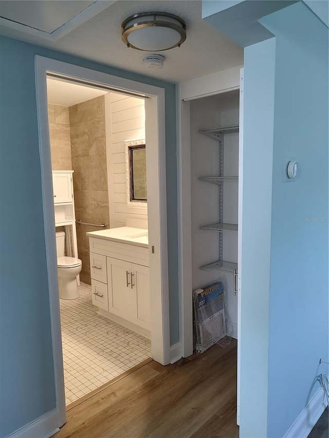 bathroom featuring hardwood / wood-style floors, vanity, and toilet