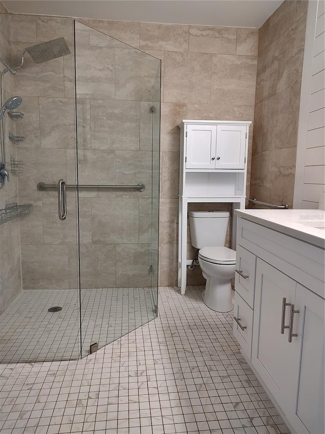 bathroom with tile patterned flooring, vanity, an enclosed shower, and toilet