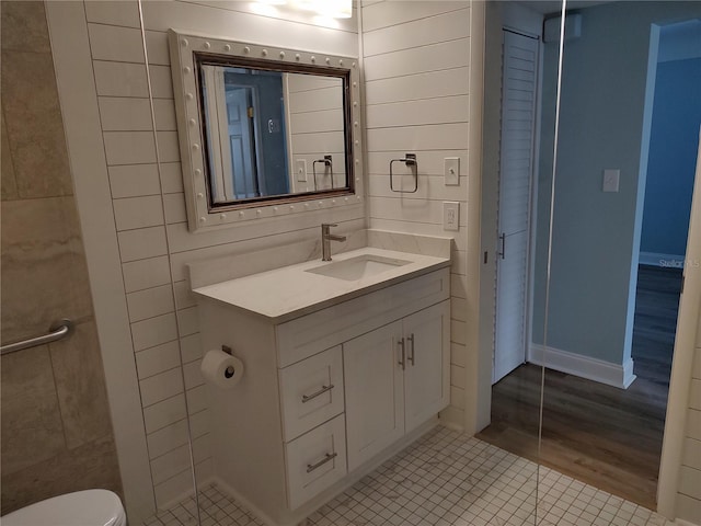 bathroom featuring tile patterned flooring, vanity, and toilet