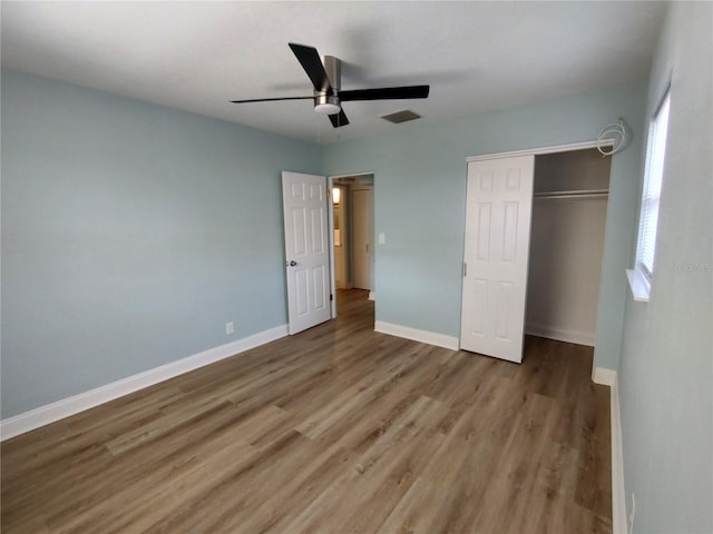 unfurnished bedroom featuring a closet, ceiling fan, and hardwood / wood-style flooring