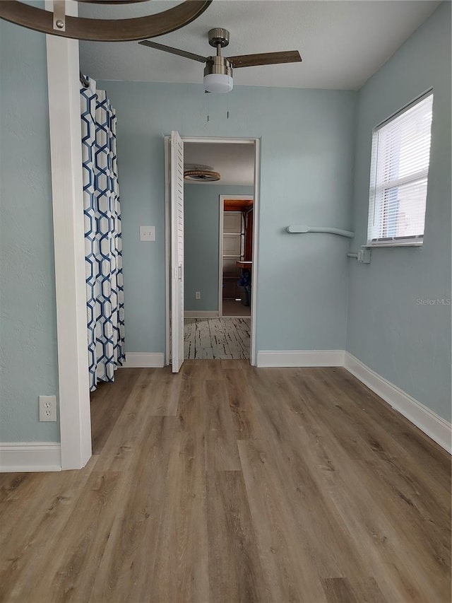 unfurnished room featuring light wood-type flooring and ceiling fan