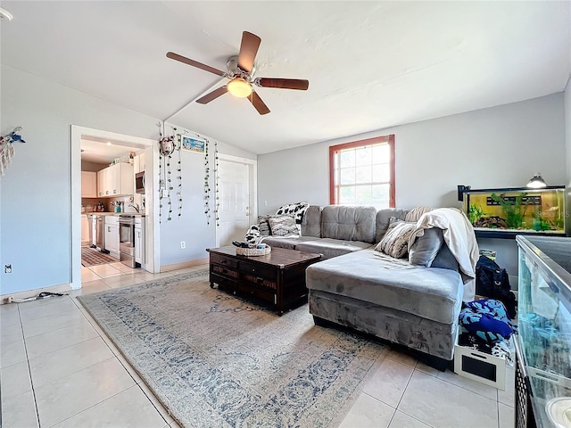 living room with ceiling fan, light tile patterned floors, and lofted ceiling