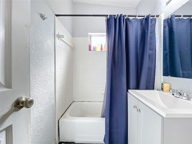 bathroom featuring vanity, lofted ceiling, and shower / tub combo with curtain