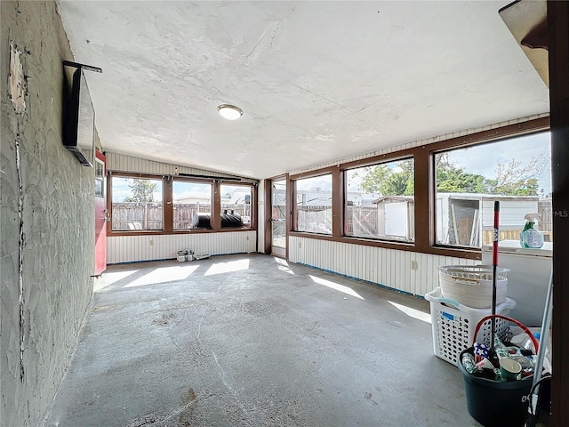 unfurnished sunroom featuring lofted ceiling