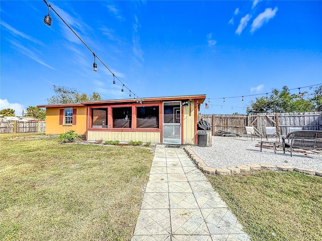 view of front of home with a front lawn, a patio area, and a sunroom