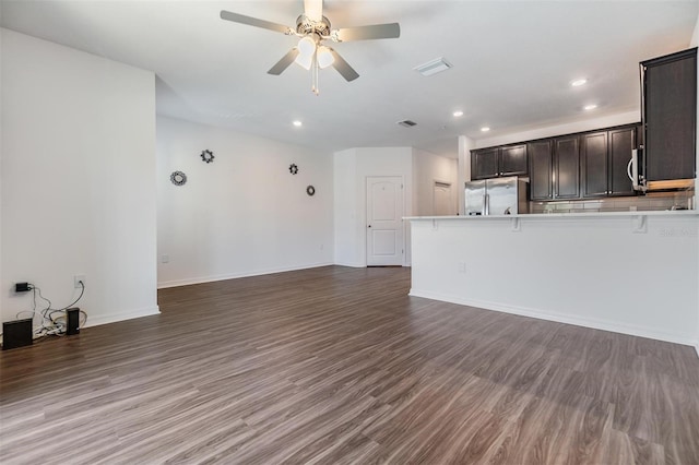 unfurnished living room with dark hardwood / wood-style floors and ceiling fan