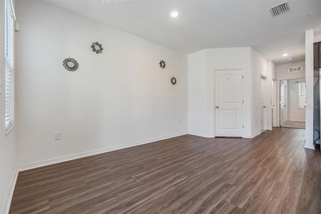 spare room with dark wood-type flooring