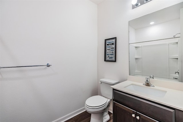 bathroom with wood-type flooring, vanity, and toilet