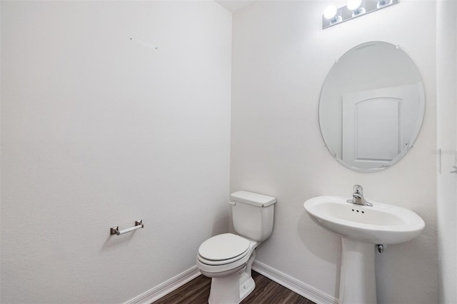 bathroom with hardwood / wood-style floors and toilet