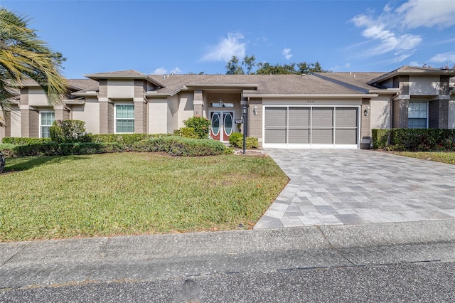 view of front of house featuring a garage and a front yard