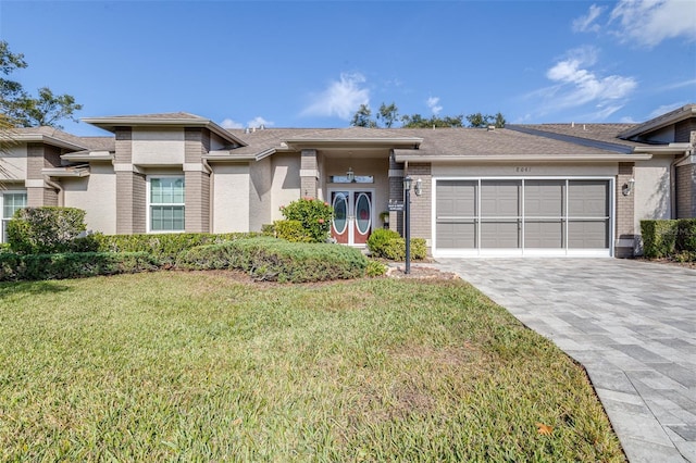 view of front facade featuring a front yard and a garage