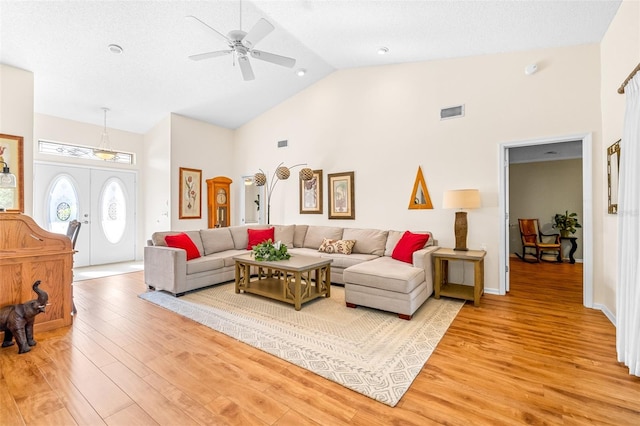 living room featuring ceiling fan, french doors, high vaulted ceiling, and wood-type flooring