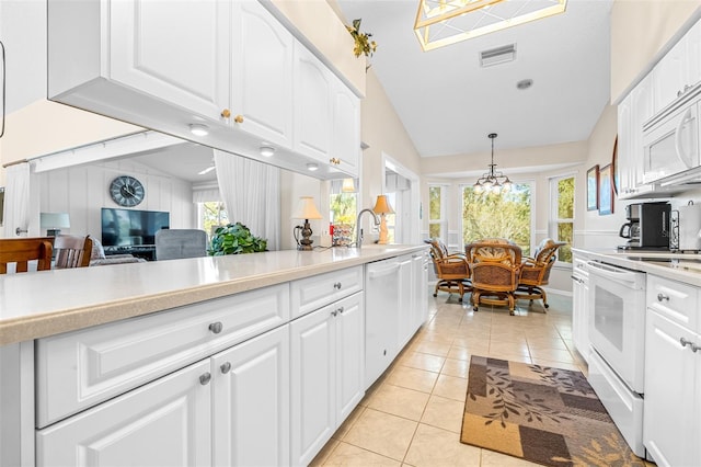 kitchen featuring white cabinets and hanging light fixtures