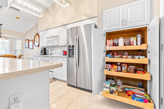 kitchen with white cabinetry, light tile patterned floors, pendant lighting, and white appliances