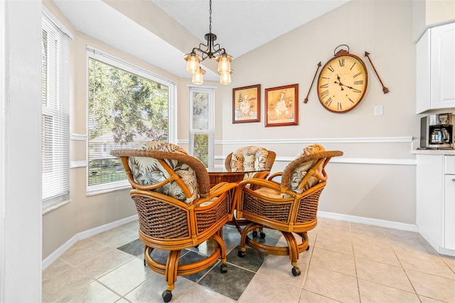 tiled dining space featuring plenty of natural light and a notable chandelier