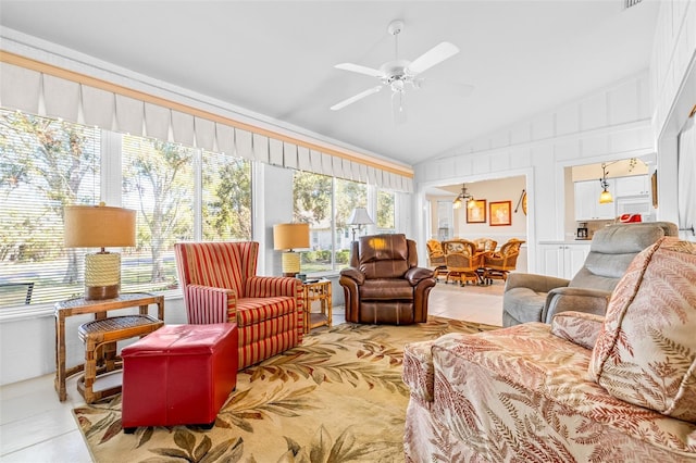 sunroom with ceiling fan, a healthy amount of sunlight, and vaulted ceiling