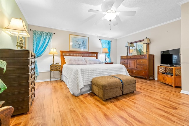 bedroom with a textured ceiling, ceiling fan, crown molding, and light hardwood / wood-style flooring