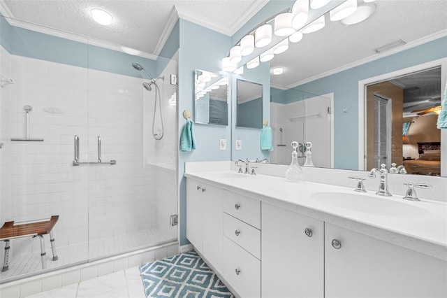 bathroom with crown molding, vanity, a shower with shower door, and a textured ceiling