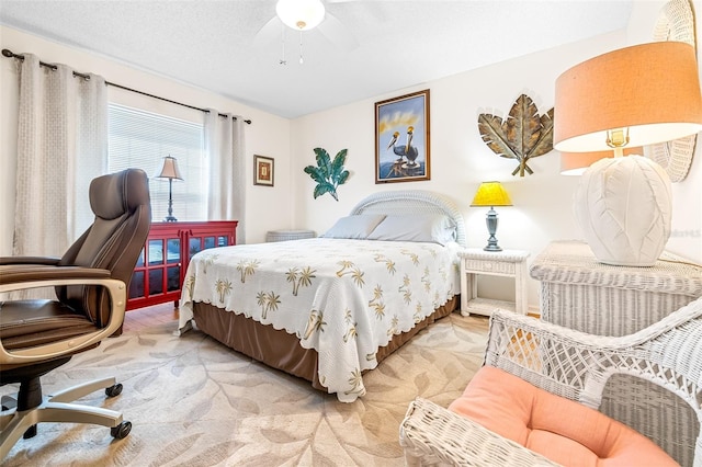 carpeted bedroom with ceiling fan and a textured ceiling