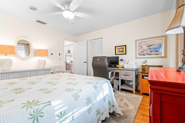 bedroom featuring ceiling fan, a closet, and light wood-type flooring