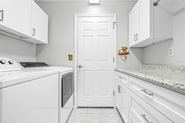 laundry room with cabinets, independent washer and dryer, and light tile patterned floors