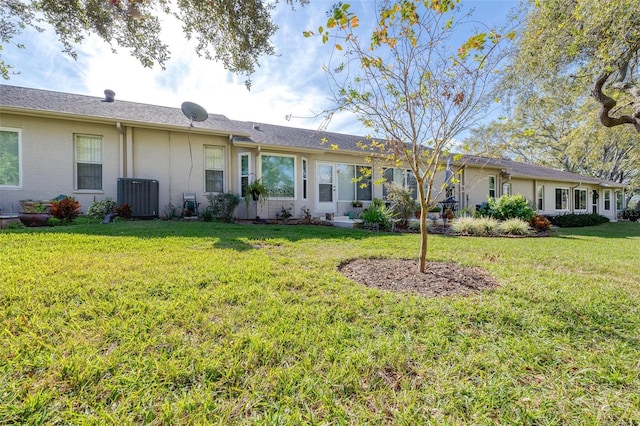 back of property featuring a yard and cooling unit