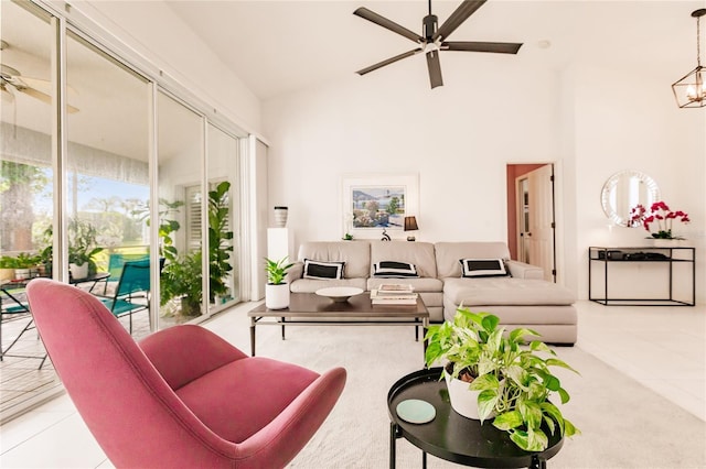 tiled living room with ceiling fan with notable chandelier and high vaulted ceiling