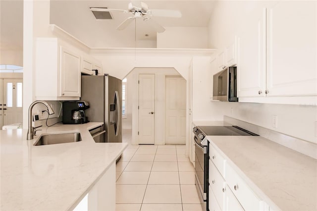 kitchen featuring white cabinetry, sink, ceiling fan, stainless steel appliances, and light tile patterned floors