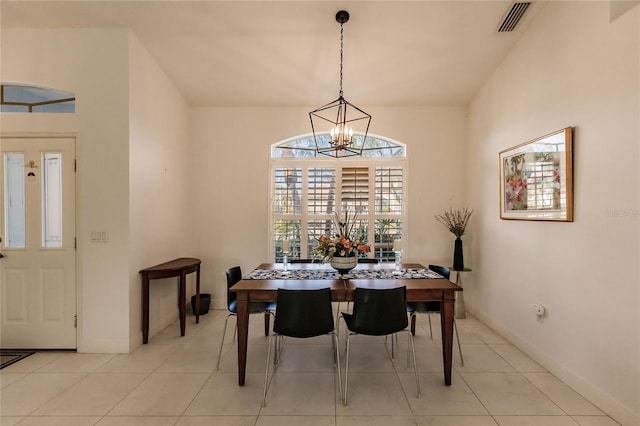 dining area with light tile patterned flooring and an inviting chandelier