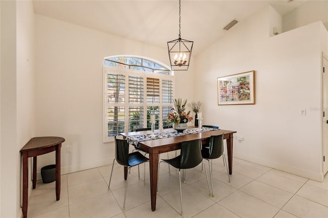 dining space featuring light tile patterned flooring, a chandelier, and vaulted ceiling