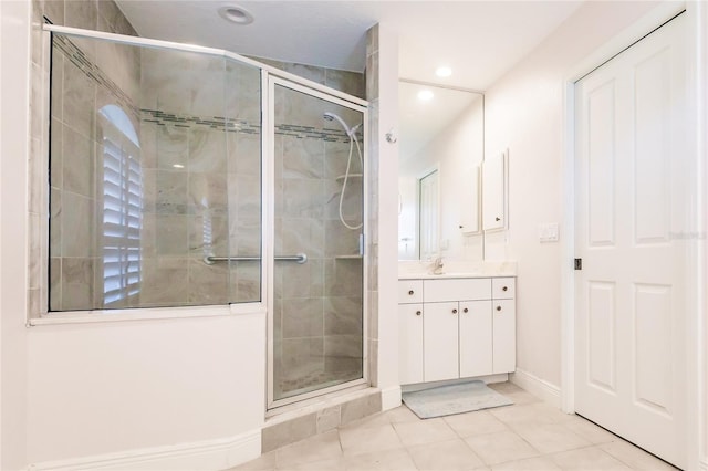 bathroom with tile patterned flooring, vanity, and an enclosed shower