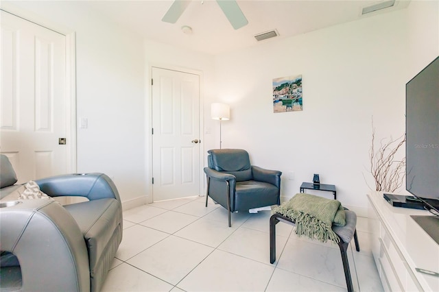 sitting room featuring ceiling fan and light tile patterned floors