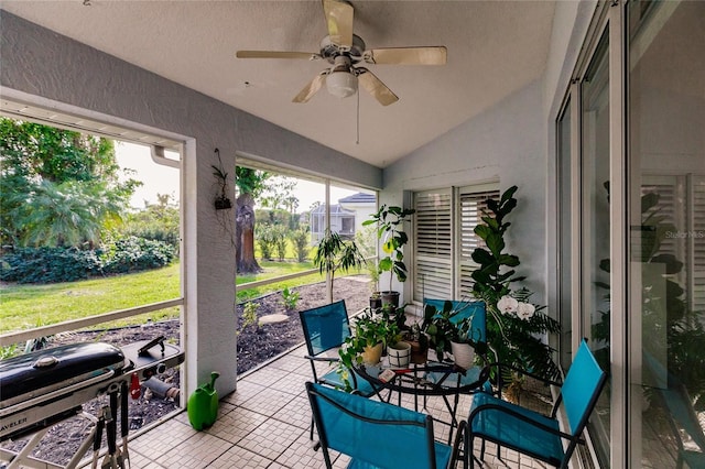 sunroom with ceiling fan and lofted ceiling