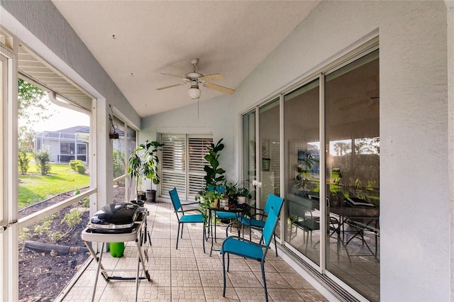 sunroom featuring ceiling fan and lofted ceiling