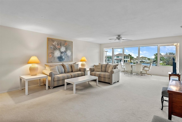 carpeted living room featuring ceiling fan and a healthy amount of sunlight