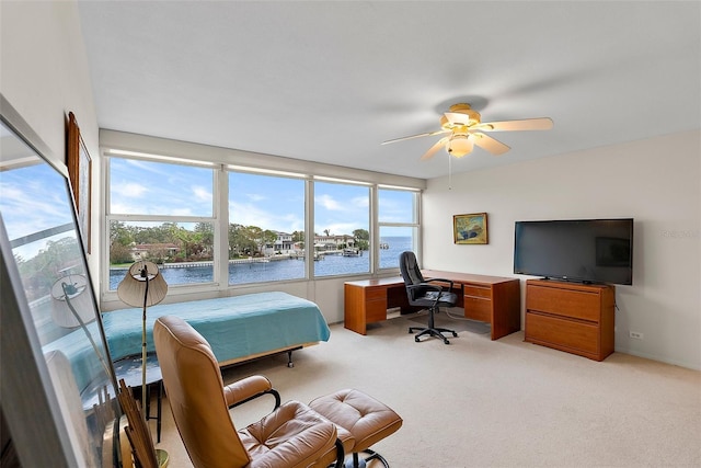 bedroom with ceiling fan, light colored carpet, and multiple windows