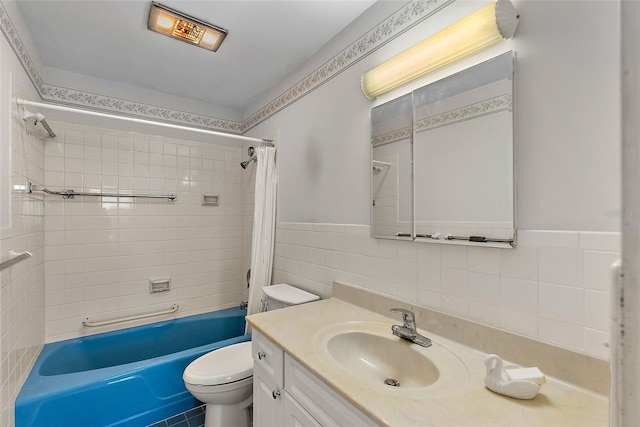 full bathroom with shower / bath combo, vanity, toilet, and tile walls