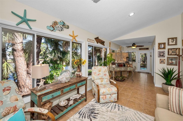 sunroom with ceiling fan, french doors, and lofted ceiling