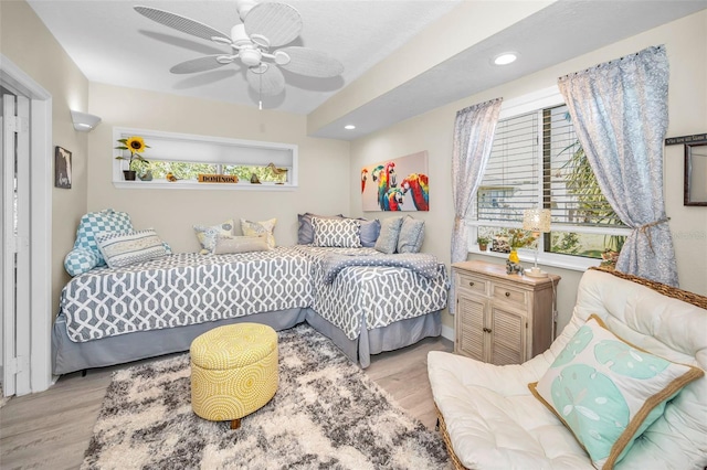 bedroom featuring ceiling fan and light hardwood / wood-style flooring