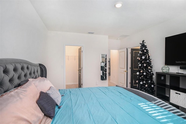 bedroom featuring a walk in closet and a closet