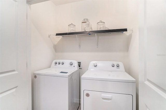 clothes washing area featuring separate washer and dryer