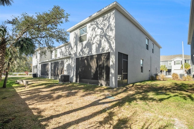 3345 Pleasant Willow Ct, Brandon, FL 33511 - back of property with stucco siding, a lawn, and a sunroom