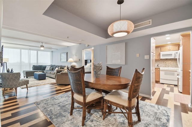 dining room featuring ceiling fan and light hardwood / wood-style flooring